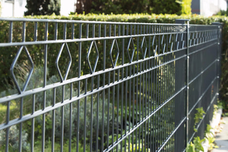 Schmuckzaun Barcelona in Anthrazit, Rautenornamente im oberen Feld vor einer Hecke
